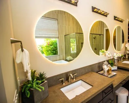 Modern Master Bathroom With Three Lighted Circular Mirrors Stock Photos