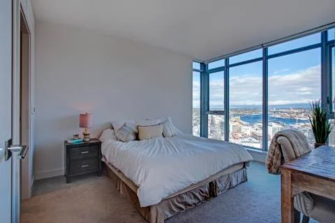 Modern master suite with floor to ceiling windows overlooking Breathtaking So Stock Photos