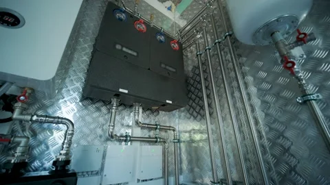 Modern mechanical room interior showing a complex HVAC system with heat pump Stock Footage 340112126