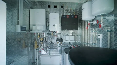 Modern mechanical room interior showing a complex HVAC system with heat pump Stock Footage 340112972
