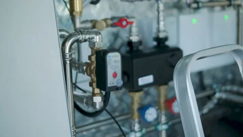 Modern mechanical room interior showing a complex HVAC system with heat pump Stock Footage 340113020