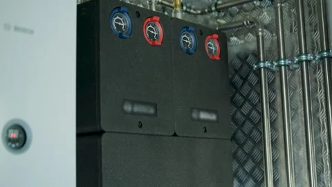 Modern mechanical room interior showing a complex HVAC system with heat pump Stock Footage 340113021