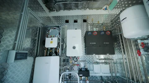 Modern mechanical room interior showing a complex HVAC system with heat pump Stock Footage 340113155