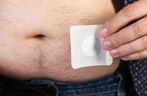 A modern medical patch for prostatitis and urinary tract infections. A man glues Foto stock