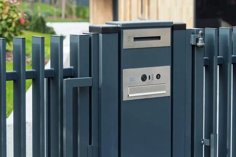 Modern metal mailbox with gate intercom at private house entrance, clean Stock Photos