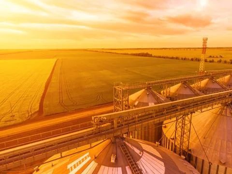 Modern metal silos on agro-processing and manufacturing plant. Aerial view of Stock Photos
