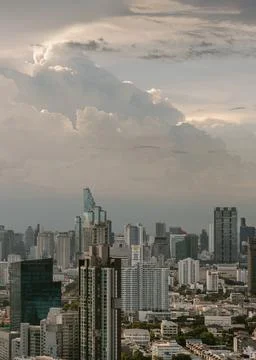 A modern metropolis unfolds beneath a dramatic, cloud-swept sky. Sleek skys.. Stock Photos