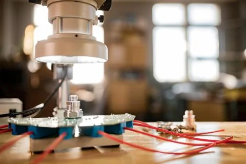 Modern microscope, connectors component and large green microcircuit in works Stock-Fotos