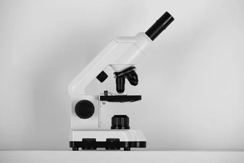 Modern microscope on light background. Medical equipment Stock Photos