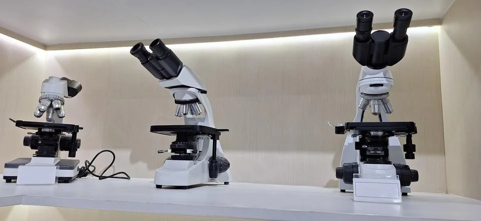 Modern microscope on white table, space for text Stock Photos