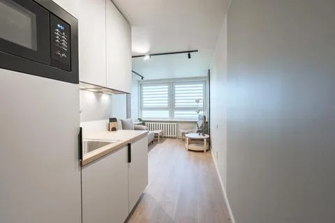 Modern Minimal Studio Apartment With Kitchenette and Cozy Living Area in Ne.. Stock Photos