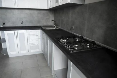 Modern minimalism style kitchen interior in monochrome tones. Custom kitchen Stock Photos