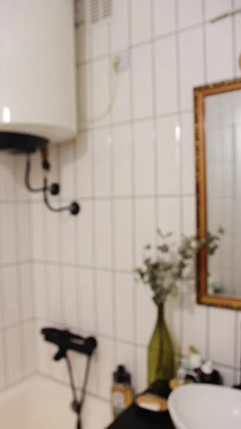 Modern minimalist bathroom interior with a blurred focus, featuring a golde.. Stock Footage 343532166