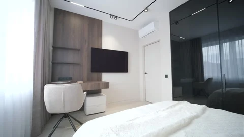 Modern minimalist bedroom with large bed and natural daylight. Stock Footage 330003768