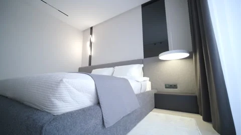 Modern minimalist bedroom with large bed and natural daylight. Stock Footage 330004182