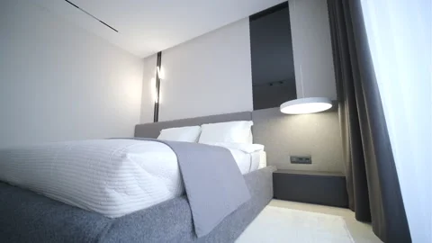 Modern minimalist bedroom with large bed and natural daylight. Stock Footage 330004183