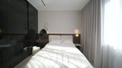 Modern minimalist bedroom with large bed and natural daylight. Stock Footage 330006728
