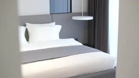 Modern minimalist bedroom with large bed and natural daylight. Stock Footage 330006937