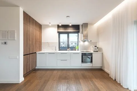 Modern Minimalist Kitchen Interior With White Cabinets, Wood Flooring and B.. Stock Photos