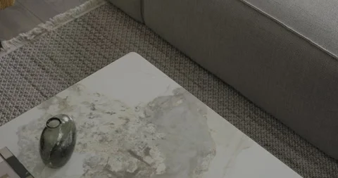Modern minimalist marble table in a living room interior design with sofa chair Stock Footage 277768419