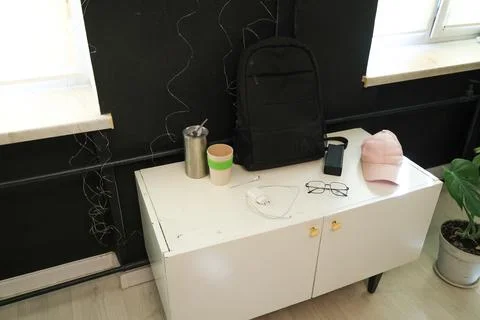 Modern minimalist setup with backpack, cap, and tech accessories on a white.. Stock Photos