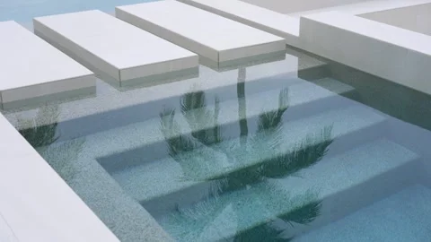 Modern minimalist swimming pool with rectangular stepping stones appear to float Stock Footage 295551575