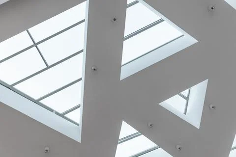 Modern minimalist white ceiling with triangular skylights 스톡 사진