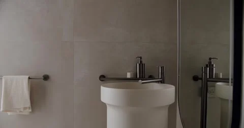 Modern Minimalistic Bathroom Interior with Sleek Fixtures and White Towel Stock Footage 342804483