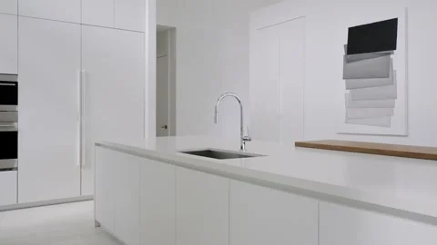 Modern minimalistic kitchen with silver sink designed with monochromatic color Stock Footage 262161400