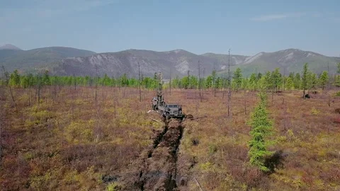 Modern mining equipment is test boring the ground in search of the golden ore Stock Footage 287481031