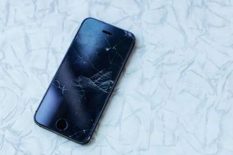 Modern mobile smart phone with broken cracked screen. Cellphone Stock Photos