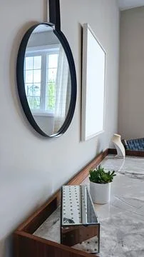 Modern mockup interior design featuring a round mirror, minimalist decor, and a Stock Photos