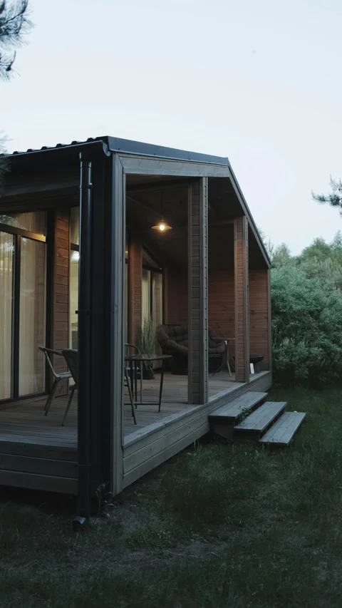 A Modern Modular House Surrounded by Nature at Dusk, Radiating Peacefulness and Video stock 322527178