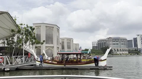 Modern mosque stands beside calm water under cloudy sky Stock Footage 340034437