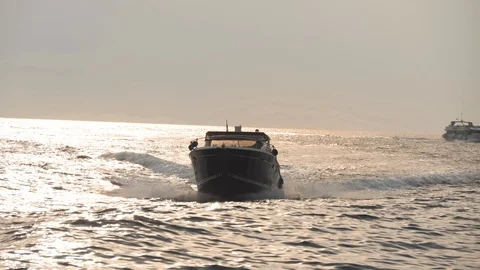 Modern motorboat moves fast on waves. Sea water reflects sunlight and shine Stock Footage 99004183