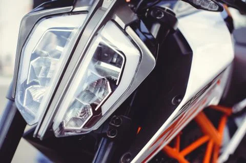 Modern motorcycle headlight, close-up on the front. Stock Photos