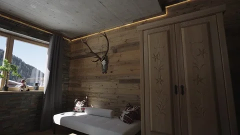 Modern mountain chalet bedroom featuring wooden walls, deer antlers, and a Stock-Footage 335198689