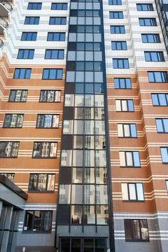 Modern multi-apartment multi-storey residential building with apartments, bottom Stock Photos