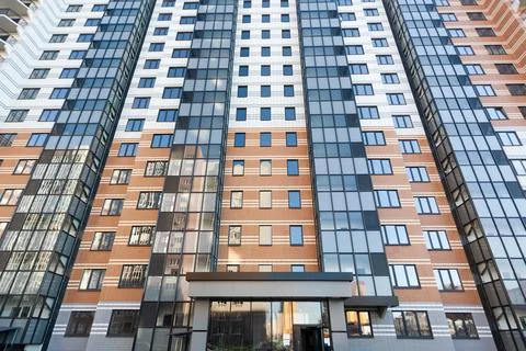Modern multi-apartment multi-storey residential building with apartments, bottom Stock Photos