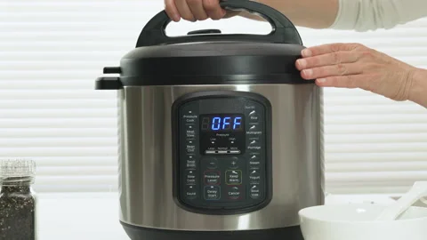 Modern multi cooker close up on kitchen table. Woman lifting lid  Stock Footage 131235542