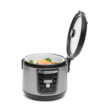 Modern multi cooker with fish and garnish on white background Foto stock
