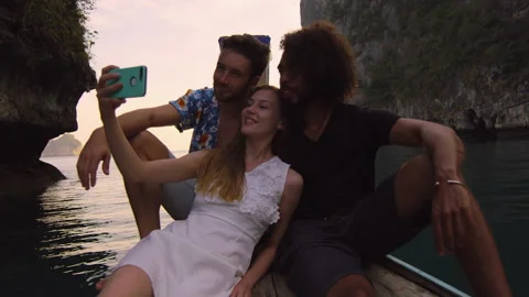 Modern multi ethnic friends taking photo or video with smartphone on long tail b Stock Footage 199477953