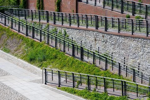 A modern multi-level ramp for the disabled with stainless steel handrails i.. Stock Photos