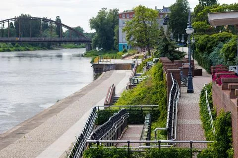 A modern multi-level ramp with stainless steel handrails on the riverbank. .. Stock Photos