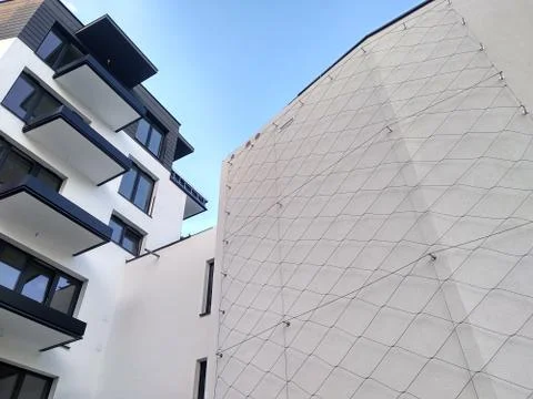 Modern multi-storey residential complex in the city. white concrete wall of t Stock Photos