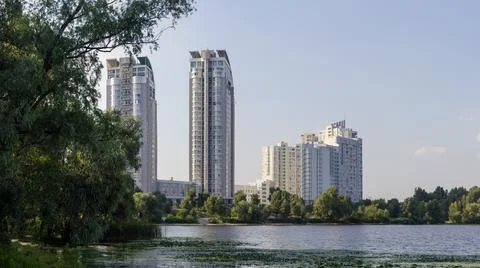 Modern multistory apartment complex on the river bank Stock Photos