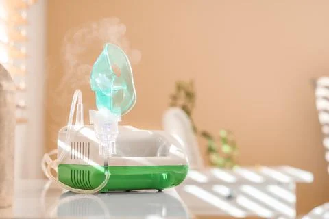 Modern nebulizer on commode in bedroom Stock Photos