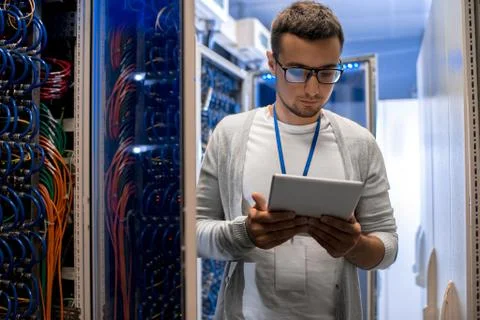 Modern Network Engineer Working with Supercomputer Foto stock