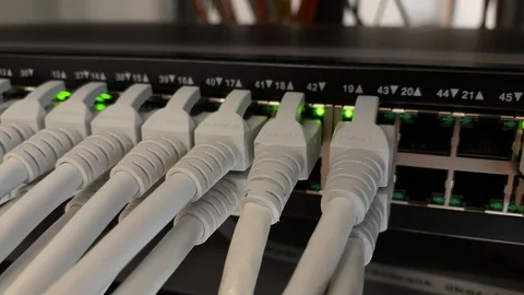 Modern network switch with cables in server room. The lights are flashing. Video stock 111849902