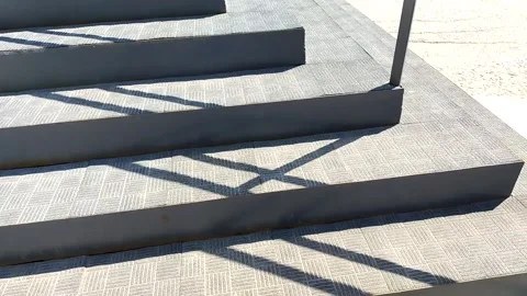 Modern new corner staircase with shadow from the steps on a sunny day, closeup. Stock Footage 310496148